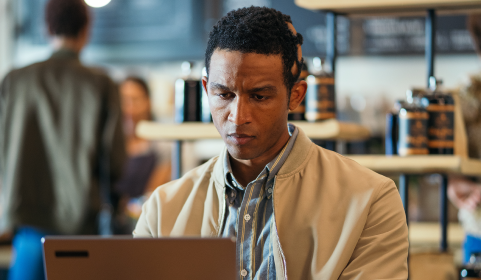 Man with severe alopecia areata after hair regrowth on his laptop